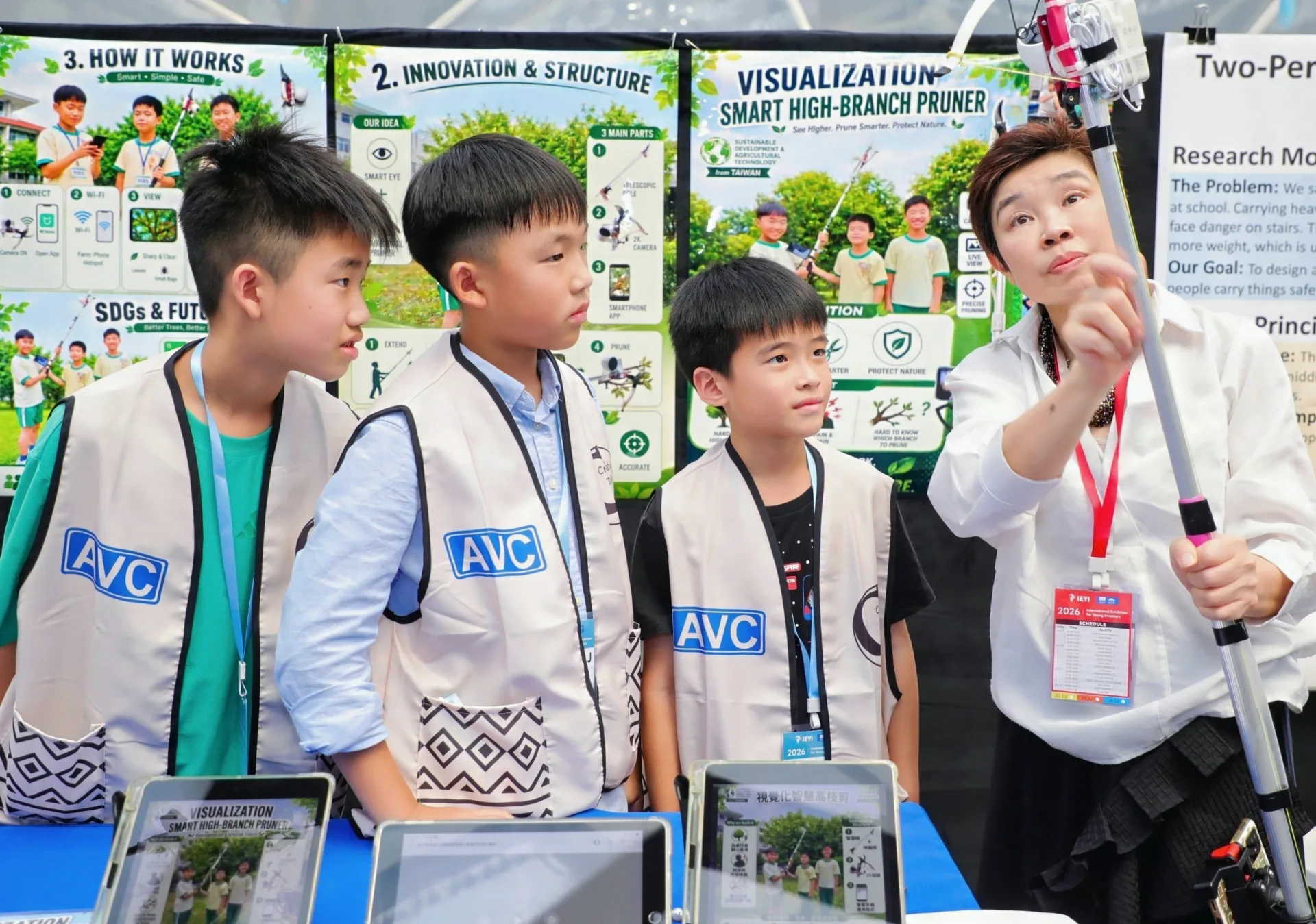 Young students demonstrate their Smart High-Branch Pruner invention